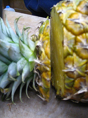 Use A Big Knife To Cut The Top Part Of The Pineapple. The Top Part Has The Hard Green Leaves. (34k)