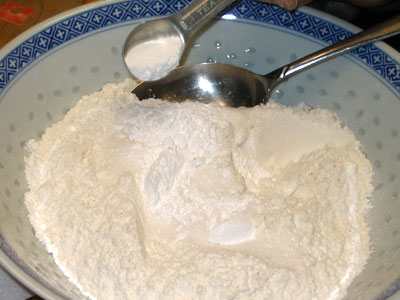 Combine All Dry Ingredients Together.  Picture Shows Baking Powder Added To Ingredients.  (29k)